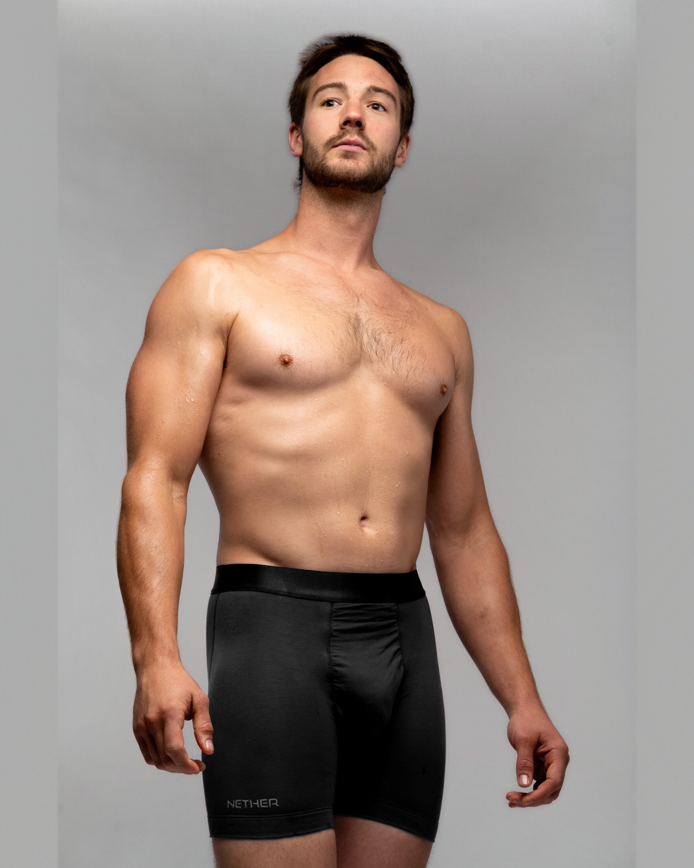 [Midnight 2] Nether Roam Boxer Brief in black, front view on model showing the full cut and satin waistband