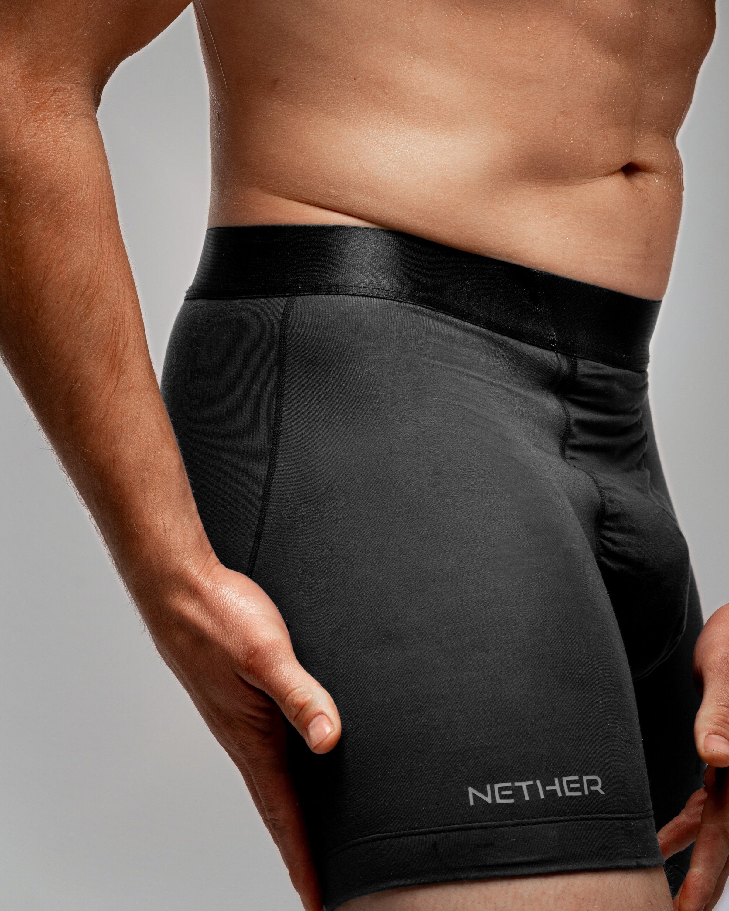 [Midnight 3] Nether Roam Boxer Brief in black, close waist-down view of the Valley Pouch panel and satin waistband
