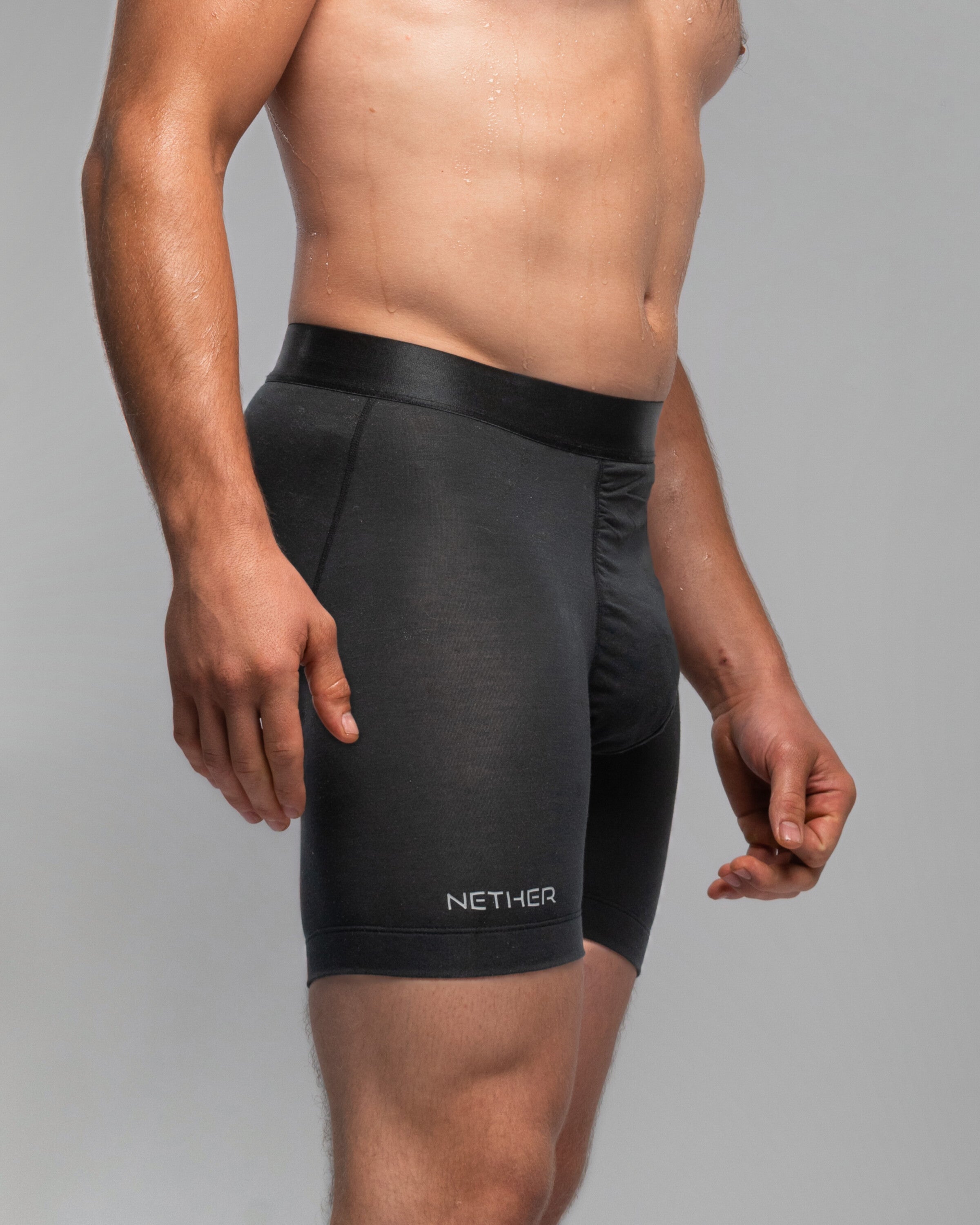 [Midnight 4] Nether Roam Boxer Brief in black, side view showing the leg hem and NETHER leg print