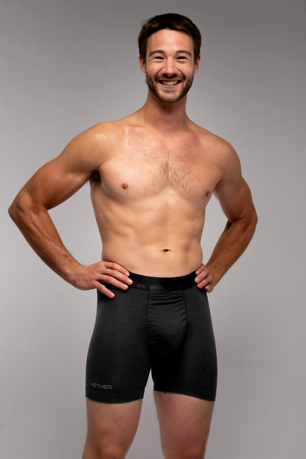 [Midnight] Nether Roam Boxer Brief in black, front view on model showing the Valley Pouch panel and satin waistband