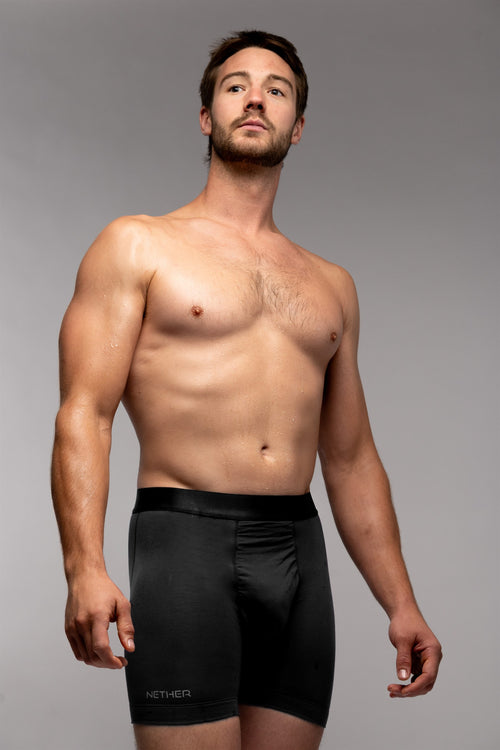 [Midnight] Nether Roam Boxer Brief in black, front view on model with the NETHER leg print visible
